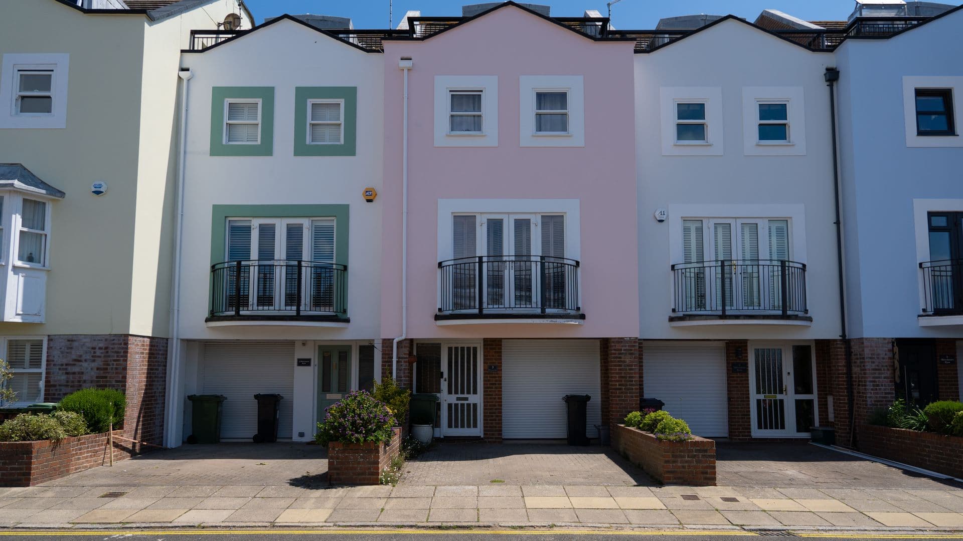 A row of terraced houses with clean windows and bright frames
